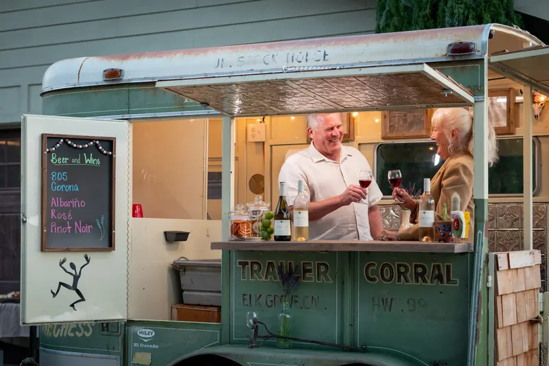 A couple toasting inside the trailer bar