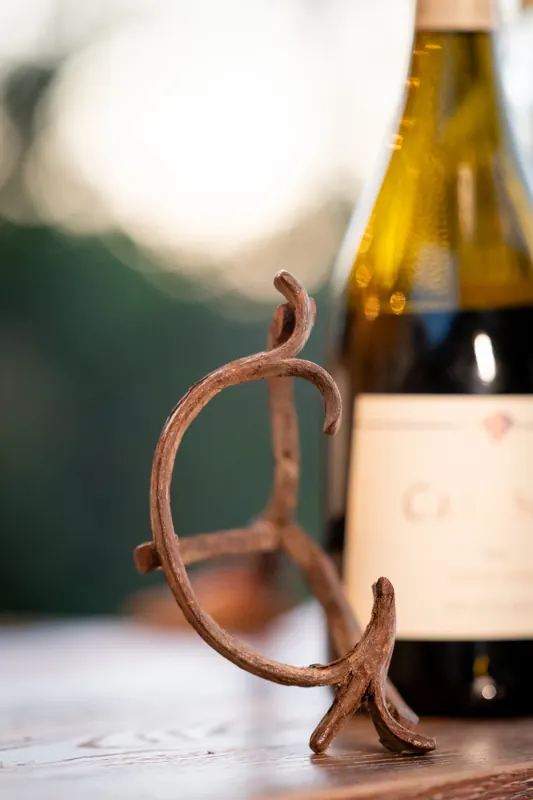 The branding iron and a bottle of Pinot Noir on the bar