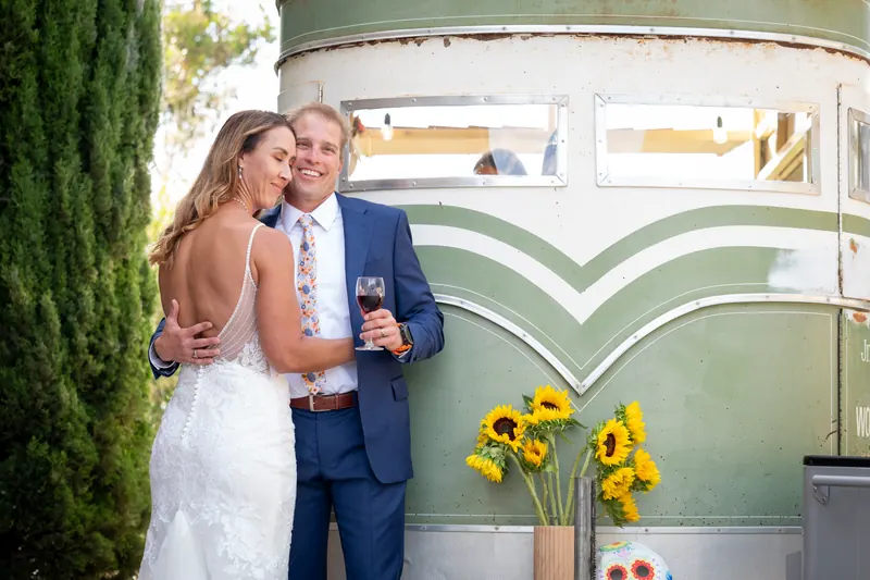 A couple embracing in front of the chevron-striped nose of the trailer