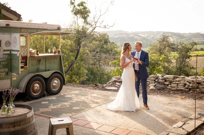 Newlyweds dancing on the patio beside the trailer with the valley beyond